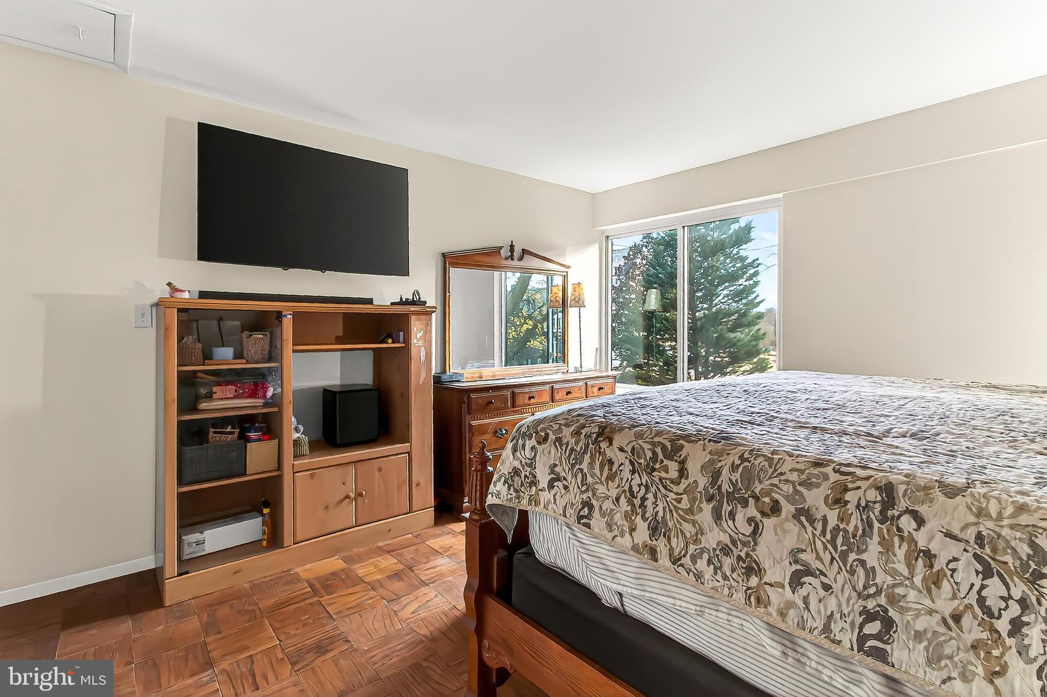 1809 Ivy Oak Square, Unit 61 Reston, VA 20190 - Photo 25 of 38 a bedroom with a bed and a flat screen tv