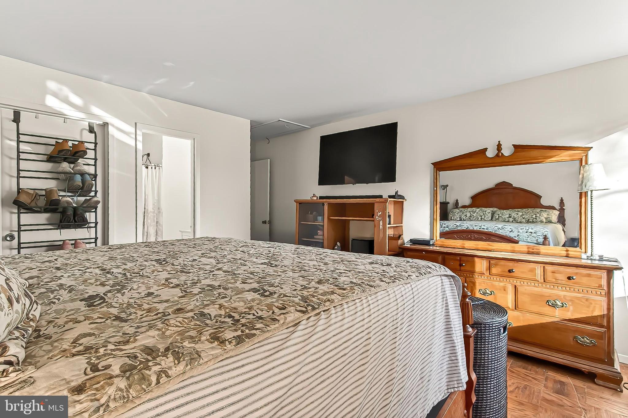 1809 Ivy Oak Square, Unit 61 Reston, VA 20190 - Photo 26 of 38 a bedroom with a bed and a flat screen tv