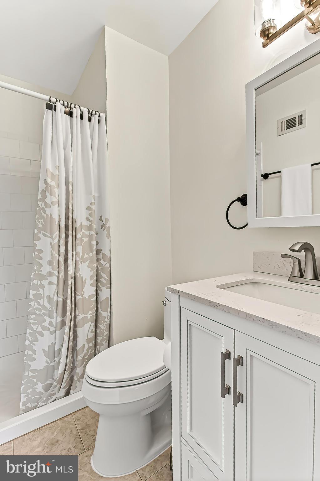 1809 Ivy Oak Square, Unit 61 Reston, VA 20190 - Photo 27 of 38 a bathroom with a granite countertop sink toilet and shower