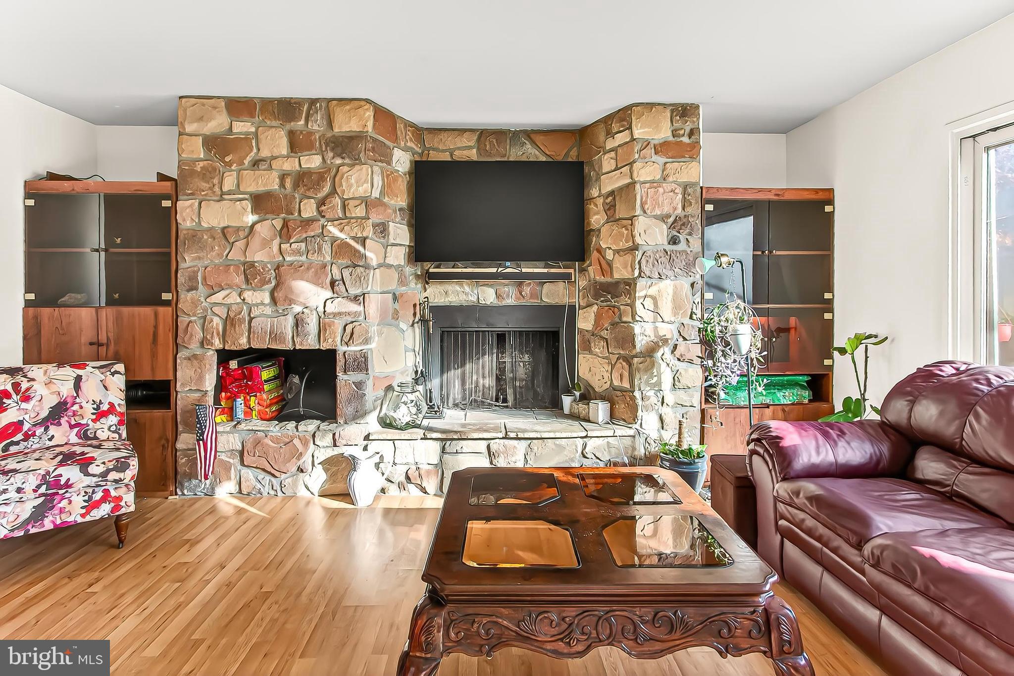 1809 Ivy Oak Square, Unit 61 Reston, VA 20190 - Photo 9 of 38 a living room with fireplace furniture and a flat screen tv