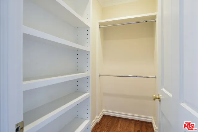 a view of walk in closet with empty racks