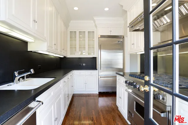 a kitchen with stainless steel appliances a sink stove and refrigerator