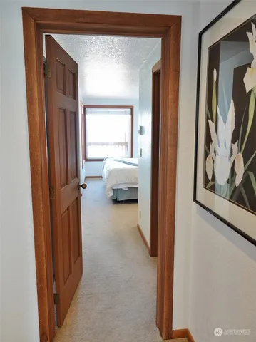 a bed sitting in a bedroom next to a window