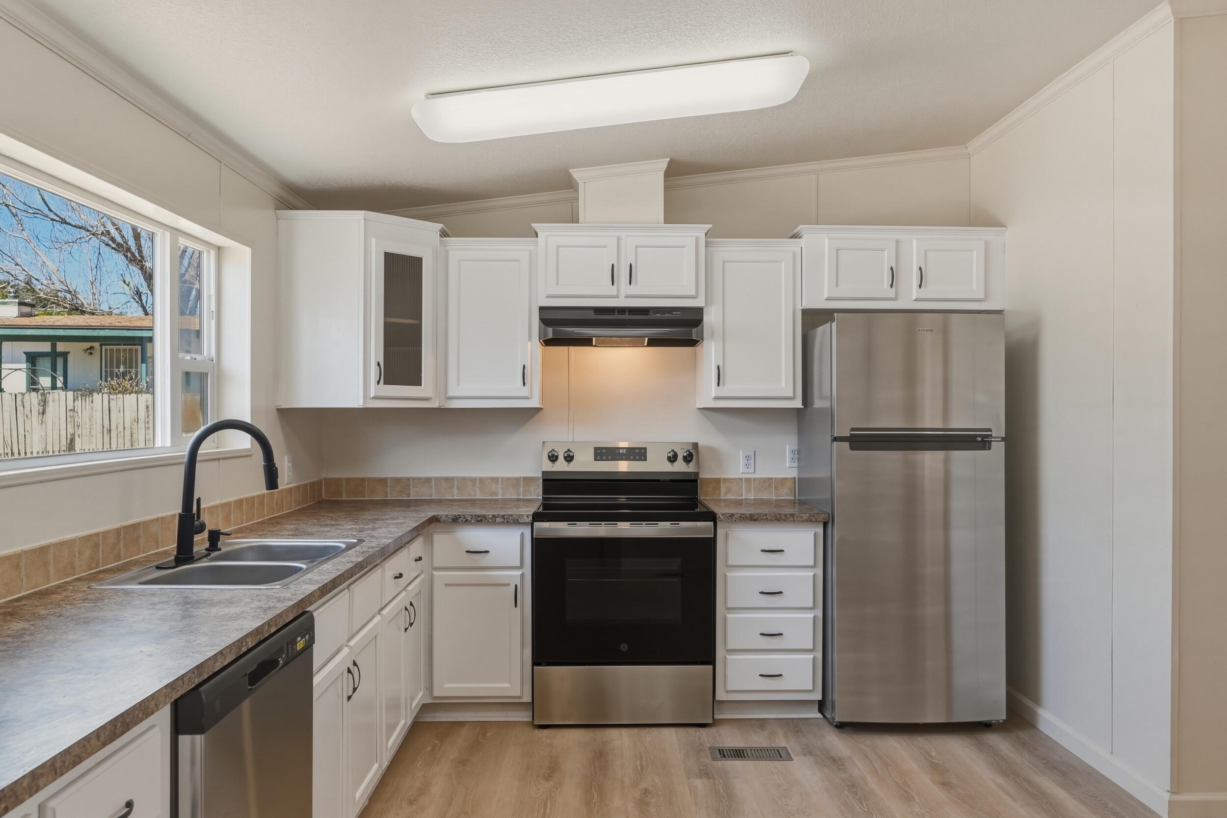 312 East Cedar Milll Road Star Valley, AZ 85541 - Photo 16 of 27 a kitchen with a stove sink and refrigerator