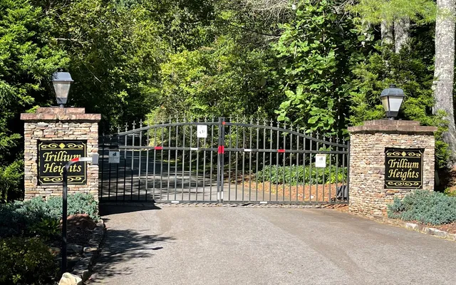 a view of a house with a wooden fence