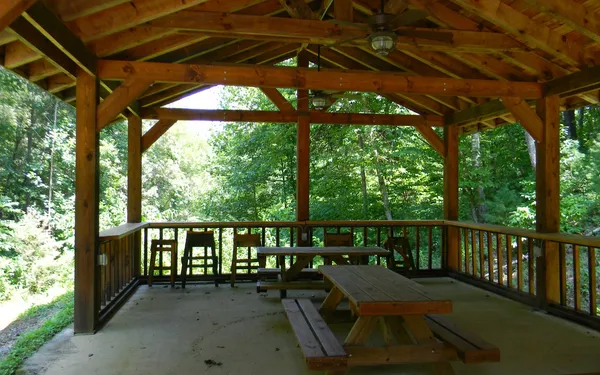 a view of a patio with a table chairs and a backyard