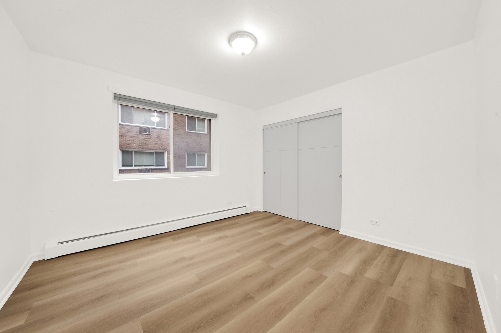 7120 North Sheridan Road, Unit 216 Chicago, IL 60626 - Photo 8 of 21 an empty room with a window