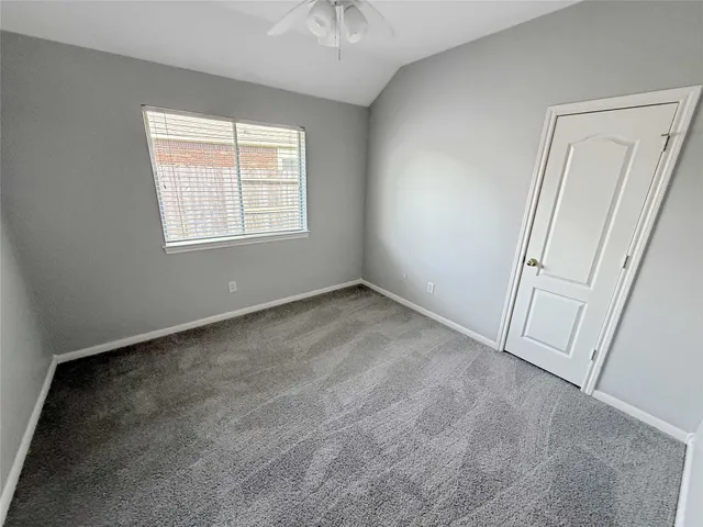 an empty room with windows and entrance