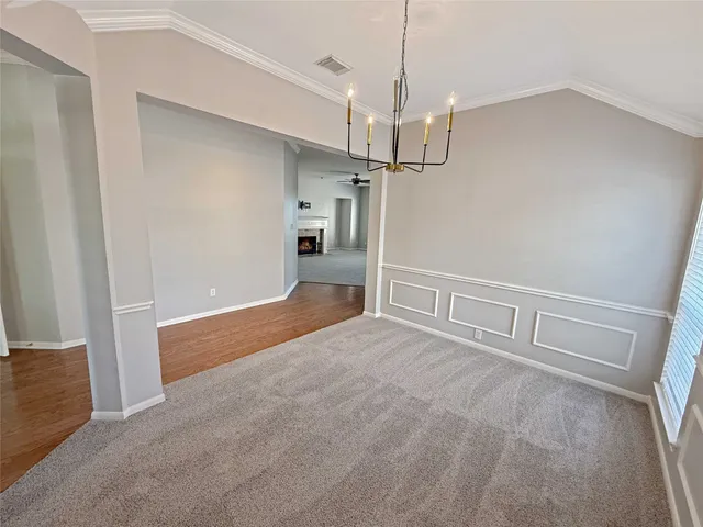 a view of a livingroom with a ceiling fan & entryway