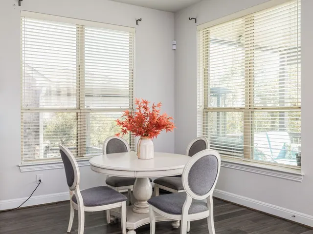 a dining room with furniture and wooden floor