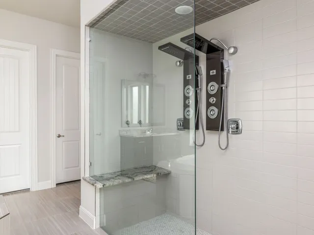 a spacious bathroom with a granite countertop sink and a large mirror