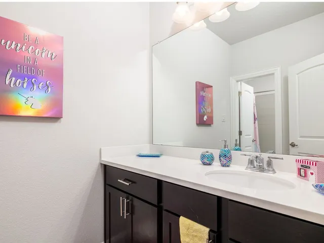 a en suite bathroom with a sink and a mirror