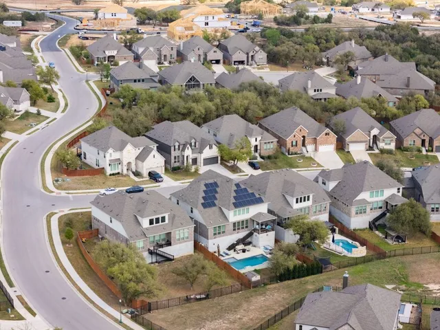 an aerial view of residential houses with outdoor space
