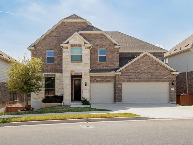 a view of a house with a yard and plants