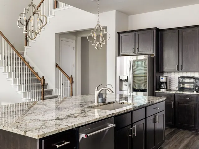 a kitchen with sink and refrigerator