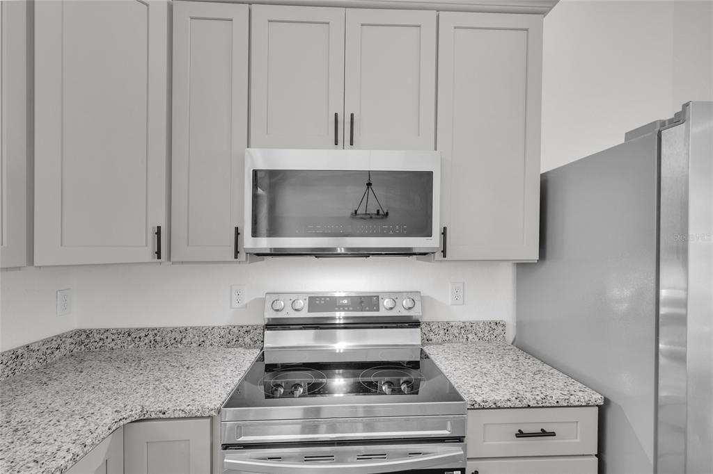 902 Southwest 2nd Street Ocala, FL 34471 - Photo 11 of 42 a stove top oven sitting inside of a kitchen