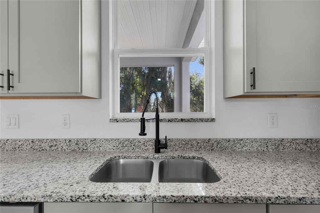 902 Southwest 2nd Street Ocala, FL 34471 - Photo 12 of 42 a kitchen with granite countertop a sink and granite top