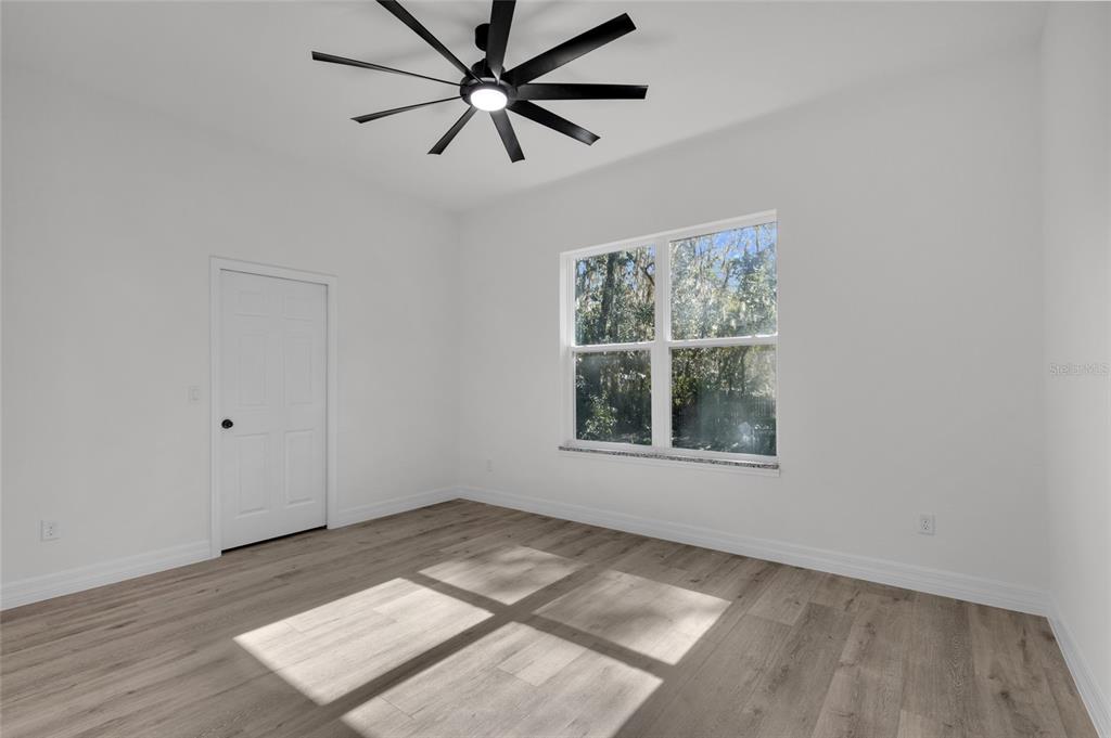 902 Southwest 2nd Street Ocala, FL 34471 - Photo 16 of 42 an empty room with a window and a ceiling fan