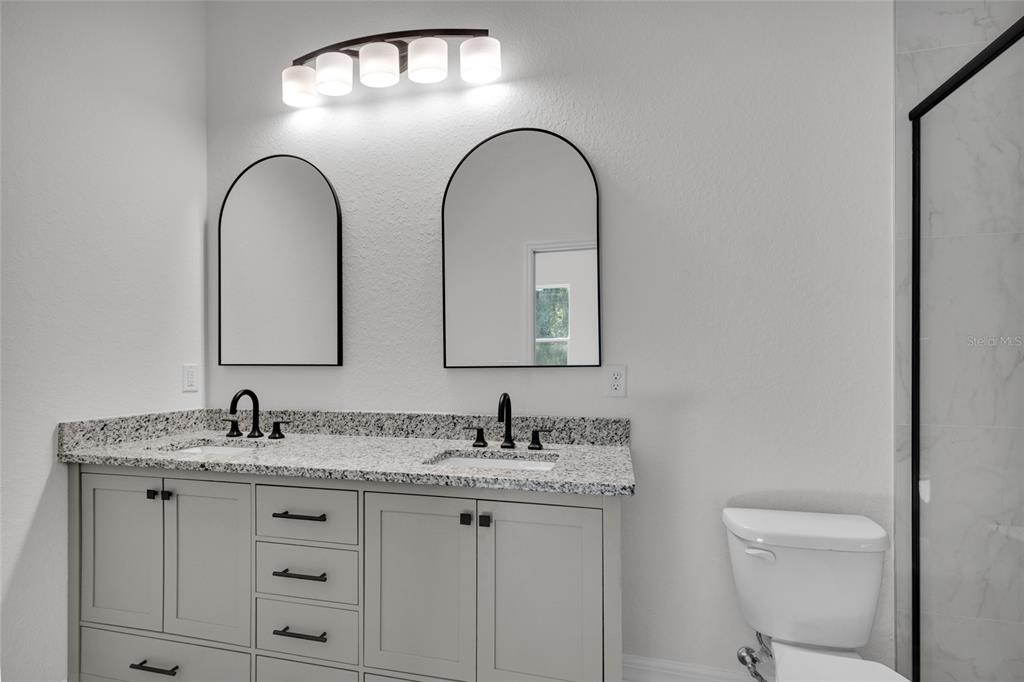 902 Southwest 2nd Street Ocala, FL 34471 - Photo 19 of 42 a bathroom with 2 sink and a mirror