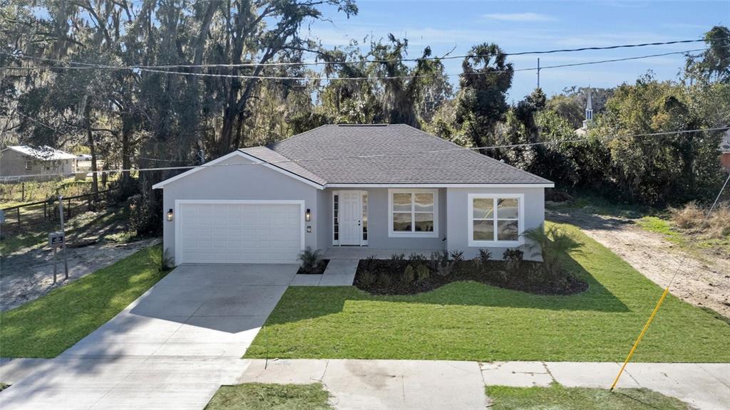 902 Southwest 2nd Street Ocala, FL 34471 - Photo 24 of 42 a aerial view of a house next to a yard and trees