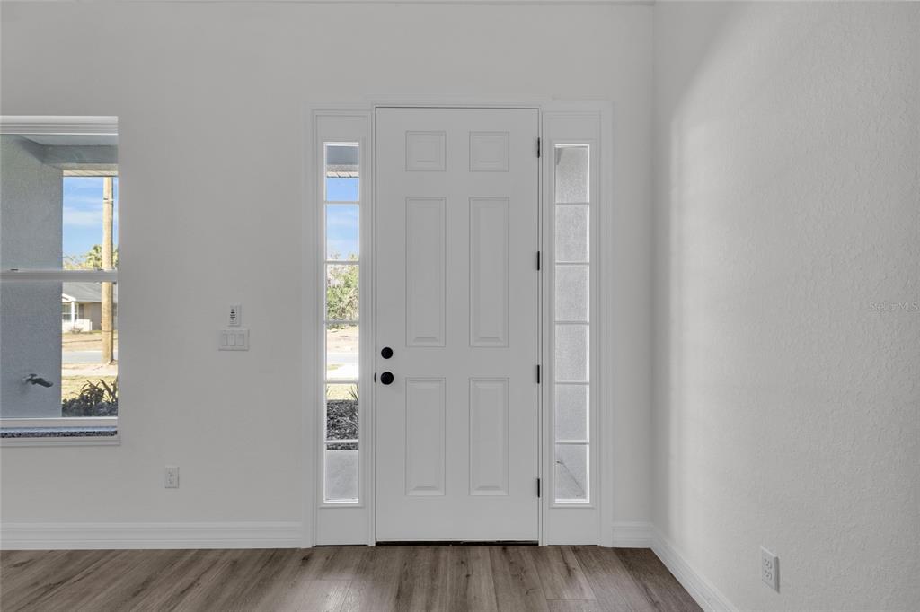 902 Southwest 2nd Street Ocala, FL 34471 - Photo 4 of 42 an empty room with wooden floor and windows