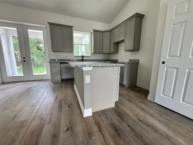 a kitchen with a sink a stove and cabinets