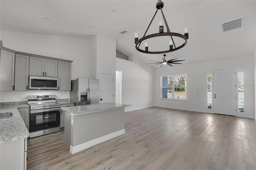 902 Southwest 2nd Street Ocala, FL 34471 - Photo 6 of 42 a view of a kitchen with a sink stainless steel appliances and cabinets