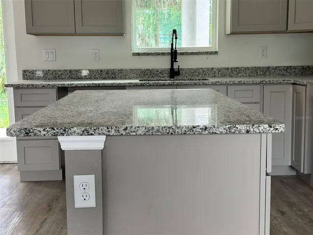 a kitchen with a sink a stove and a window