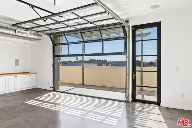 a hallway with a white stove top oven and cabinetry