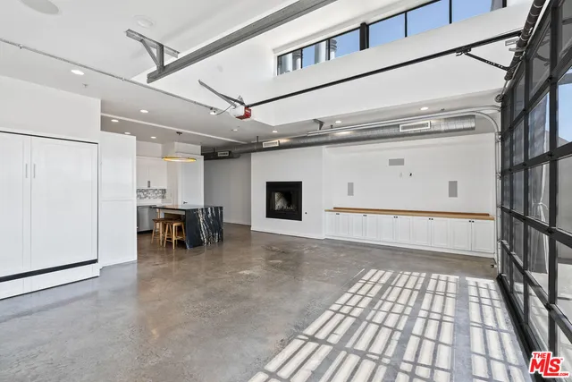 a kitchen with kitchen island a sink stove and refrigerator