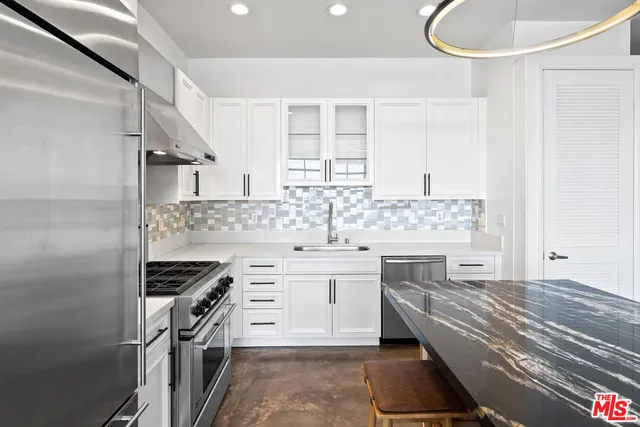 a utility room with sink dryer and washer