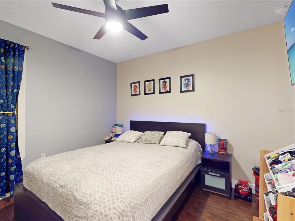 4775 Jay Drive St. Cloud, FL 34772 - Photo 21 of 49 a bedroom with a bed and a chandelier