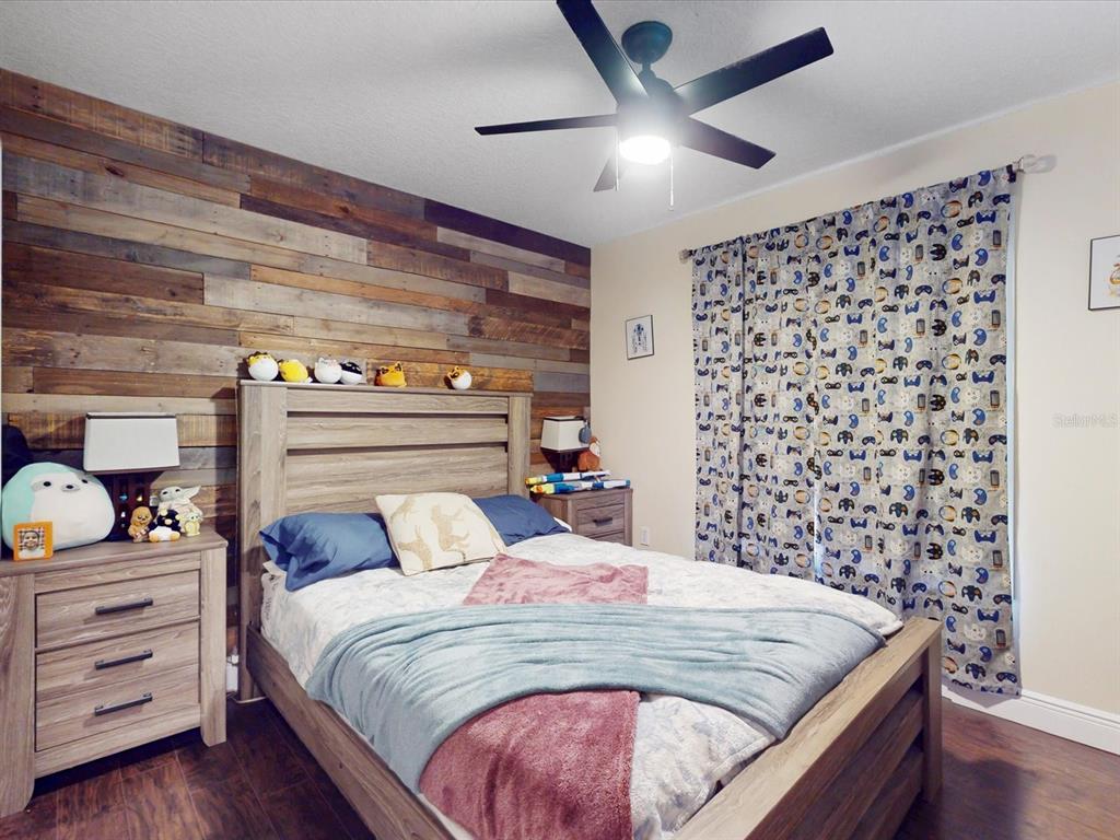 4775 Jay Drive St. Cloud, FL 34772 - Photo 25 of 49 a bedroom with a bed and a chandelier