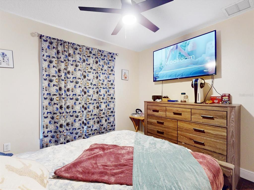 4775 Jay Drive St. Cloud, FL 34772 - Photo 26 of 49 a bedroom with a bed and a painting on the wall