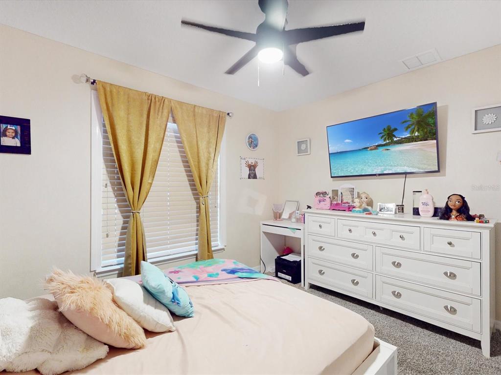 4775 Jay Drive St. Cloud, FL 34772 - Photo 29 of 49 a bedroom with a bed and a flat screen tv