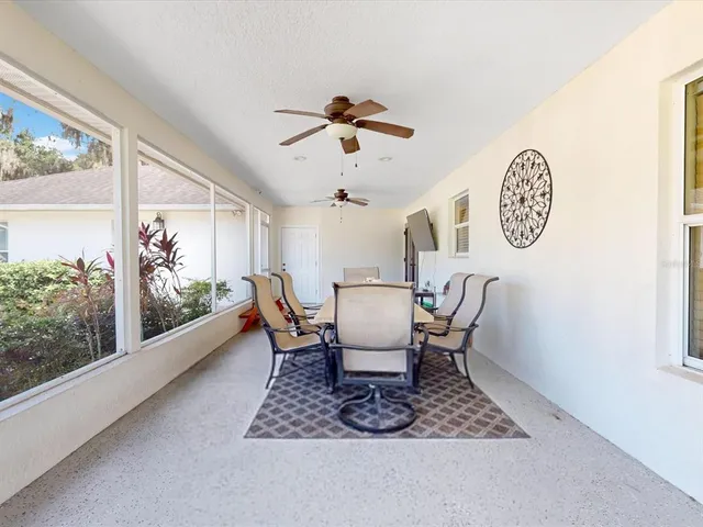 a view of a house with a yard and potted plants