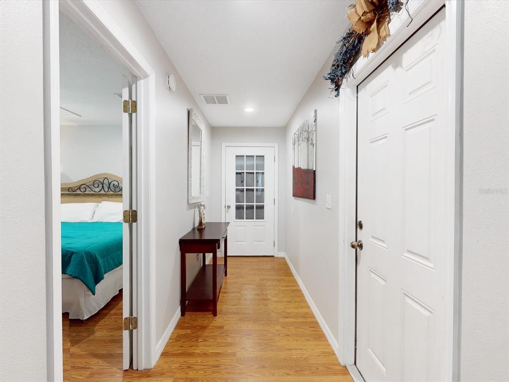 4775 Jay Drive St. Cloud, FL 34772 - Photo 33 of 49 a view of a hallway with wooden floor and staircase