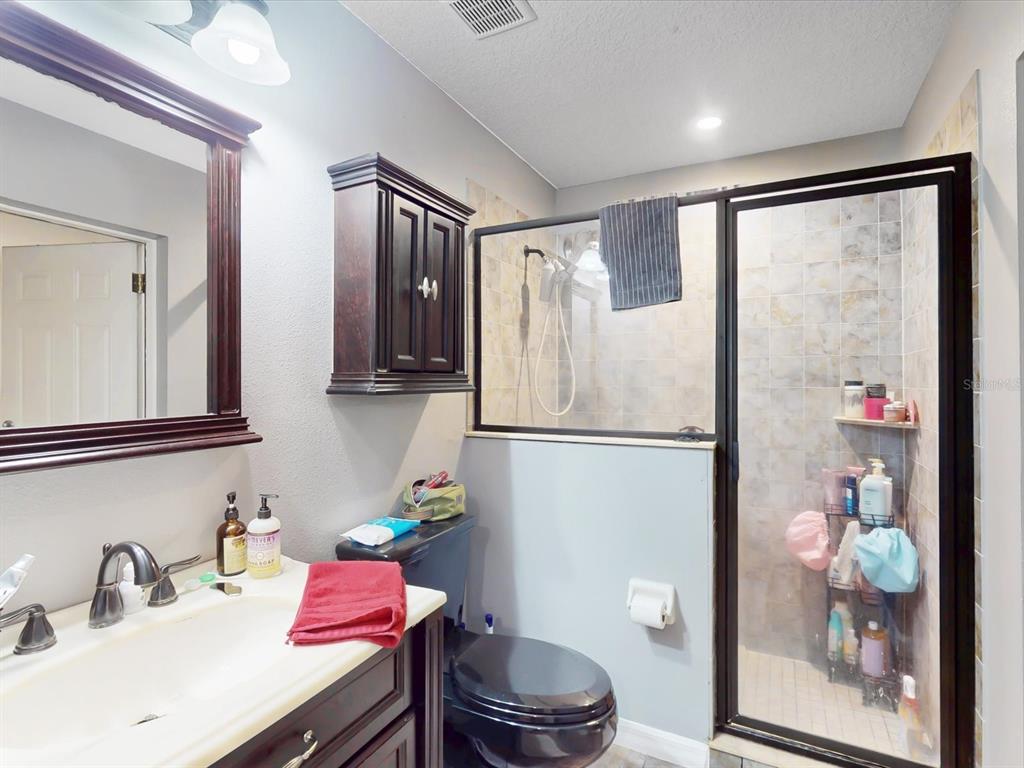 4775 Jay Drive St. Cloud, FL 34772 - Photo 35 of 49 a bathroom with a refrigerator and a sink