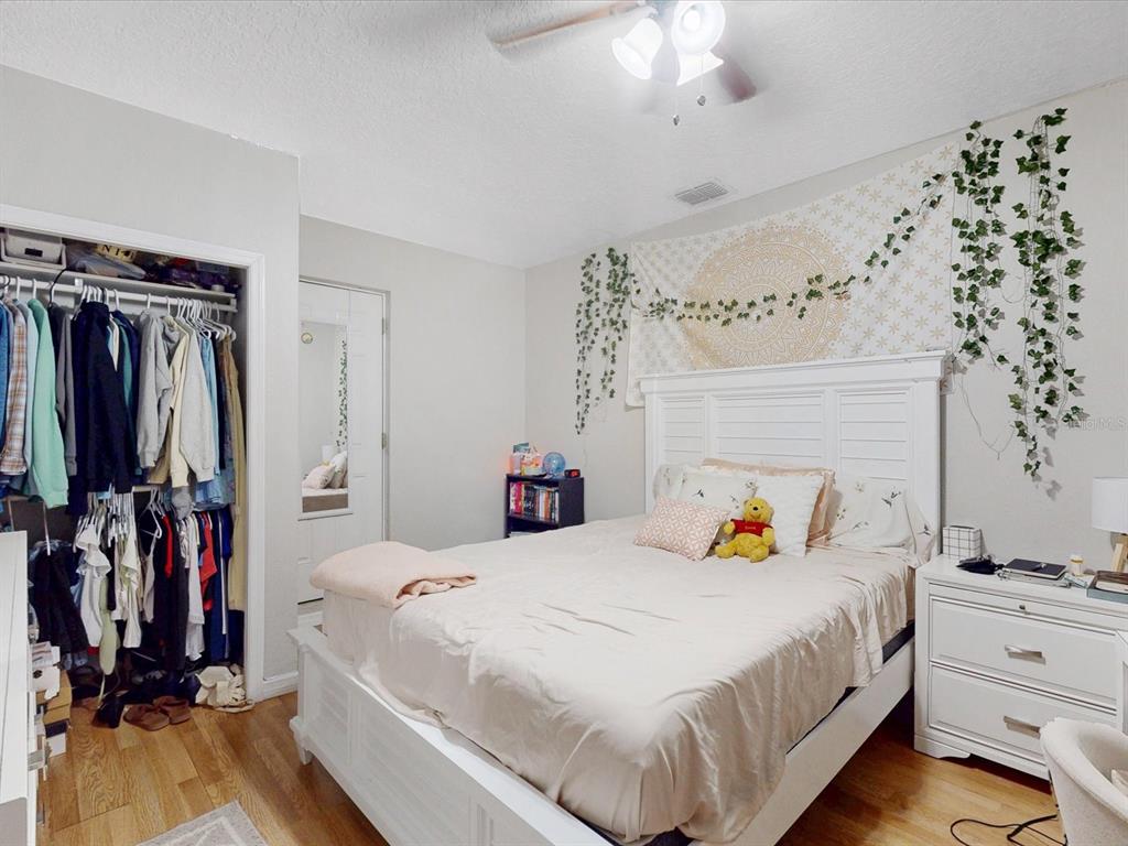 4775 Jay Drive St. Cloud, FL 34772 - Photo 36 of 49 a bedroom with bed and wooden floor