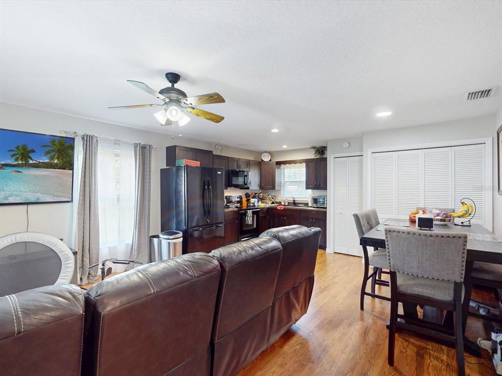 4775 Jay Drive St. Cloud, FL 34772 - Photo 37 of 49 a living room with furniture kitchen view and a chandelier