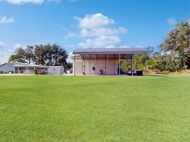 a front view of house with yard and trees