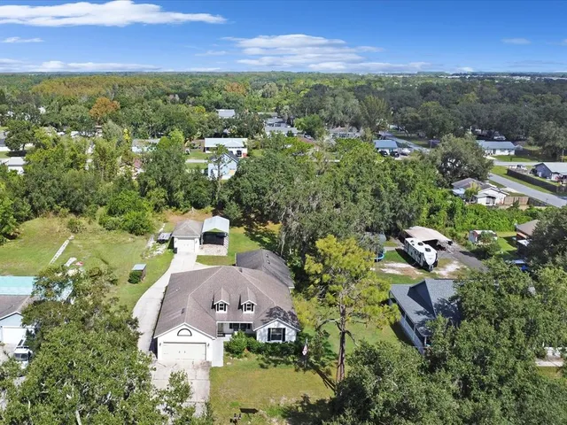 an aerial view of a house with a yard