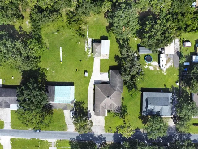 an aerial view of a house with a yard