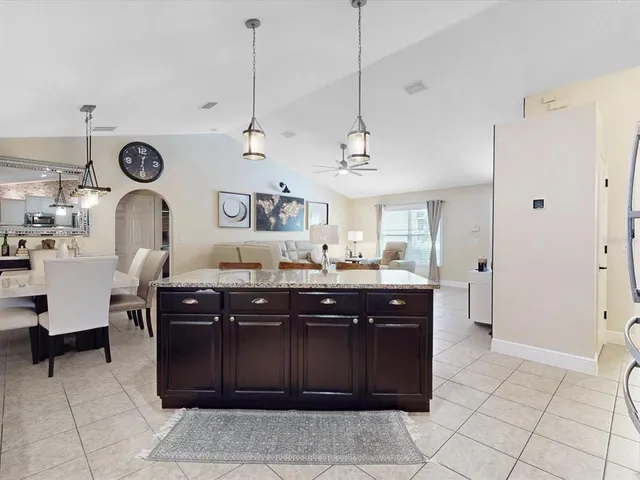 a kitchen with stainless steel appliances granite countertop a refrigerator sink and stove