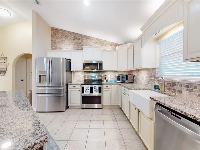 a view of a dining room with furniture and front door