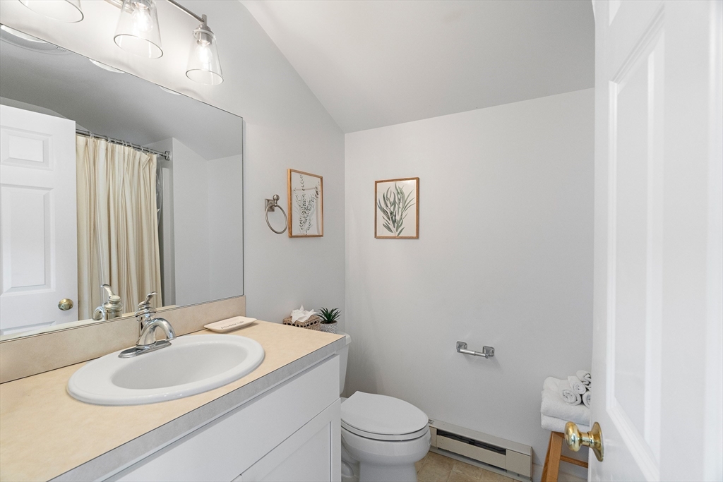 13 Young Street Edgartown, MA 02539 - Photo 11 of 29 a bathroom with a granite countertop sink mirror vanity and toilet
