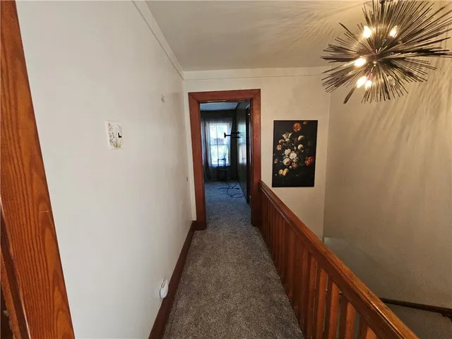 a view of a hallway to a house with wooden floor
