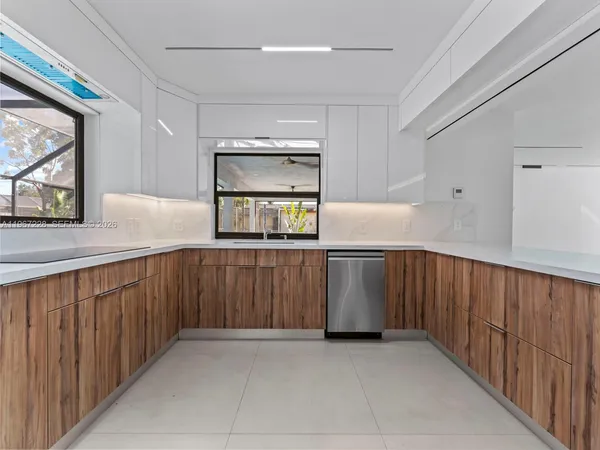 a kitchen with stainless steel appliances a stove microwave and sink