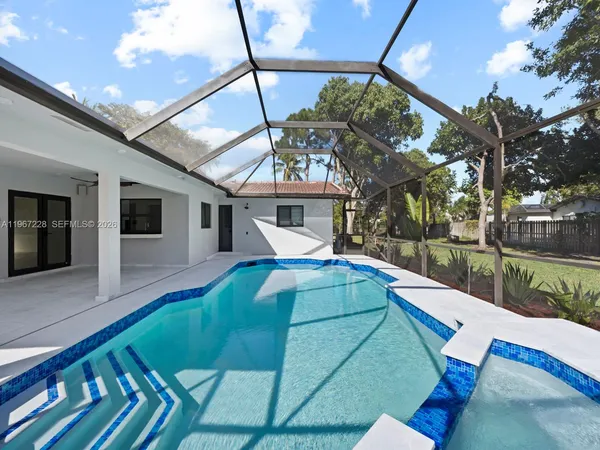a view of a house with backyard and deck