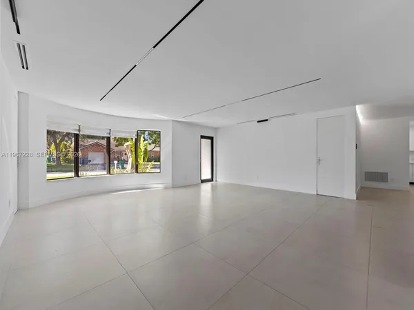 a view of a livingroom with an empty space and a window